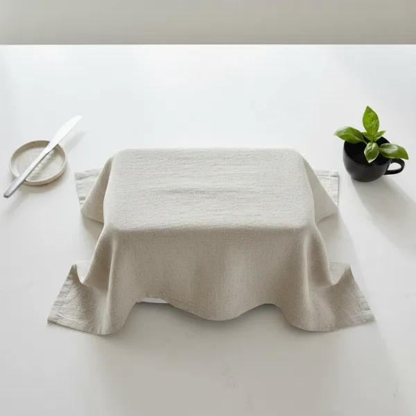 A pristine kitchen countertop featuring a covered toaster, symbolizing cleanliness and protection.