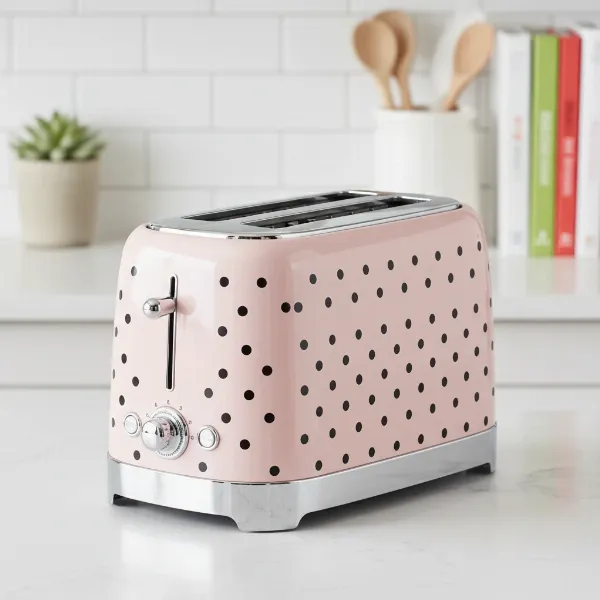 A stylish Kate Spade New York 2-Slice Toaster in blush with deco dots.