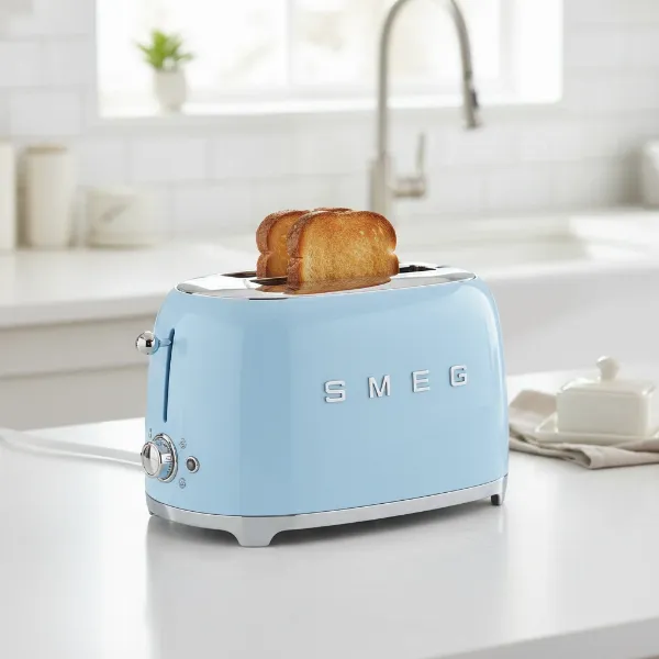 Smeg 2-slice toaster in pastel blue, showcasing retro design and chrome details.